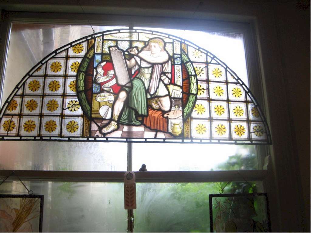 Victorian pre-raphaelite stained glass of a scribe