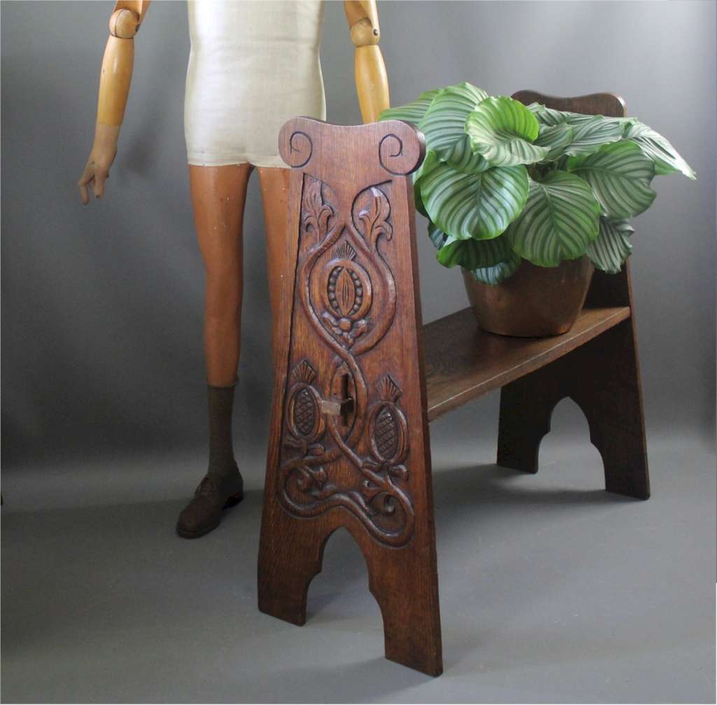 Arts and Crafts oak bench with carved pomegranates
