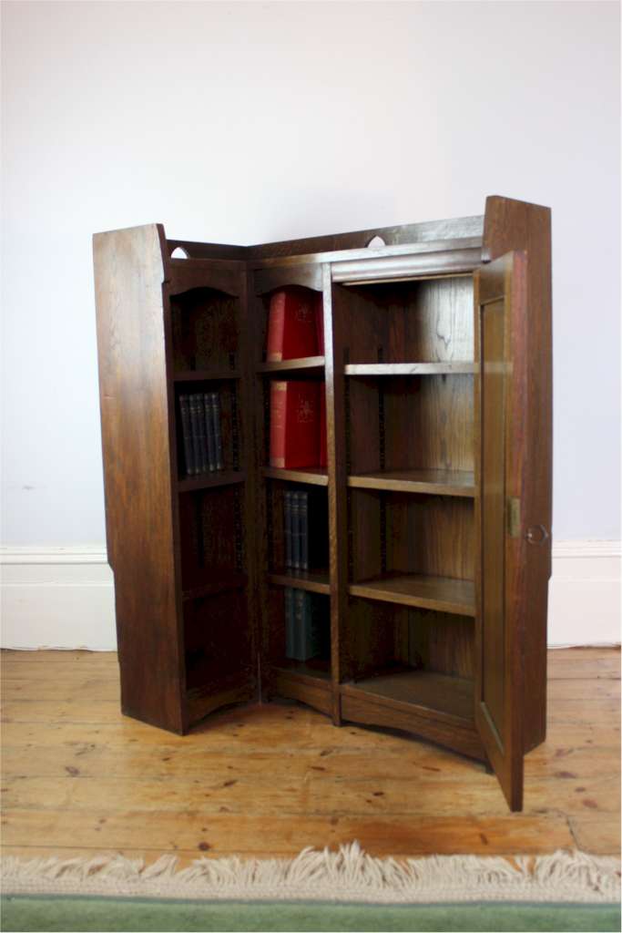 Rare Arts and Crafts Liberty & Co corner bookcase with pierced hearts