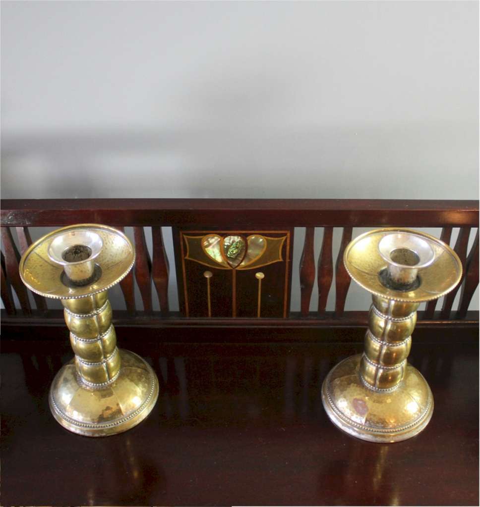 Pair of brass arts and crafts candlesticks