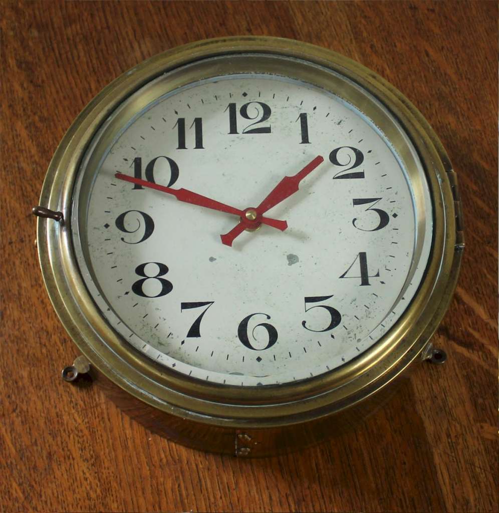 Antique brass Ships clock with  Arabic numerals