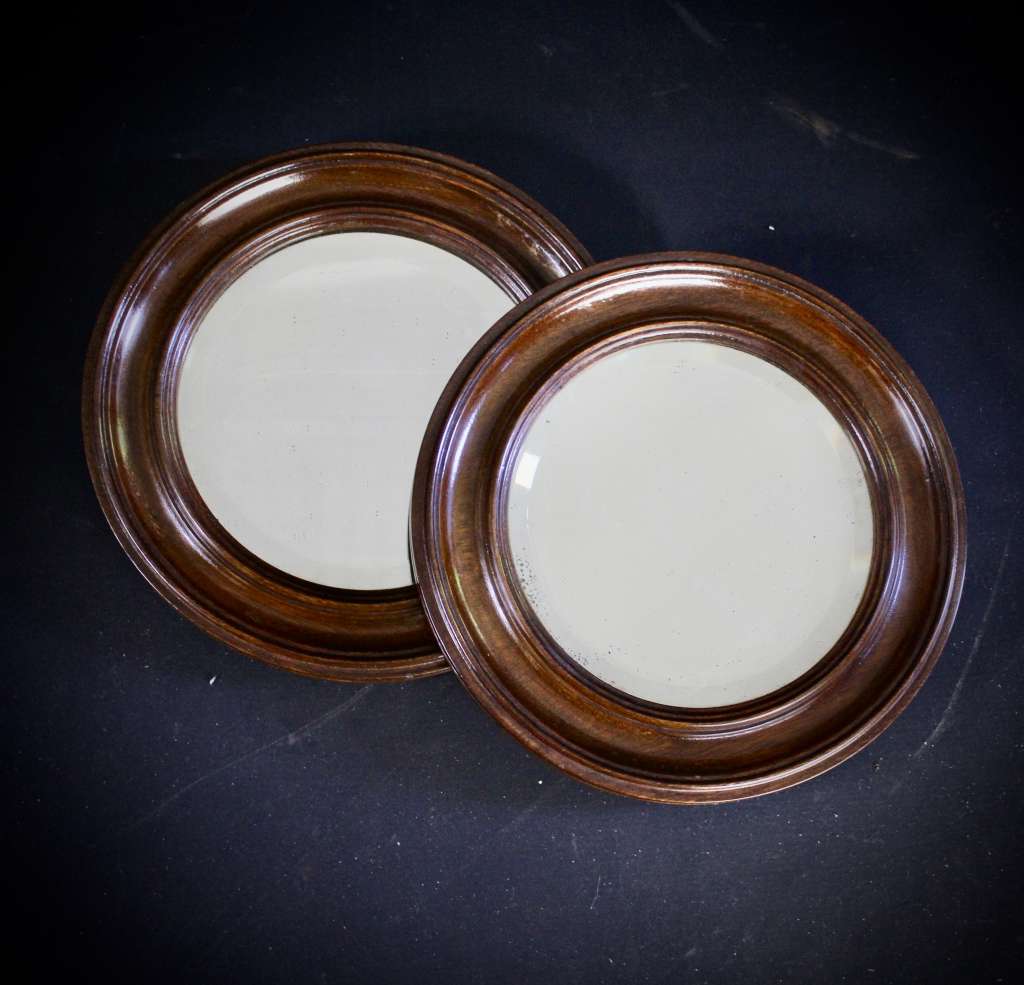 pair of oak framed circular mirrors