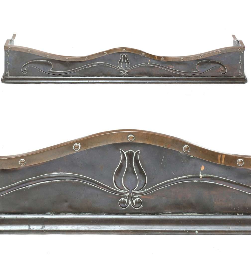 An Arts and Crafts bronze and copper fender