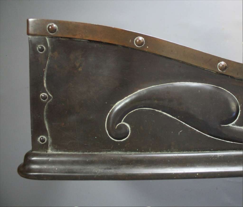 An Arts and Crafts bronze and copper fender