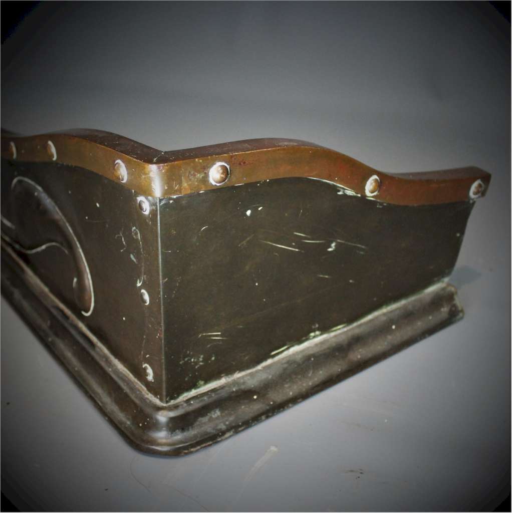 An Arts and Crafts bronze and copper fender