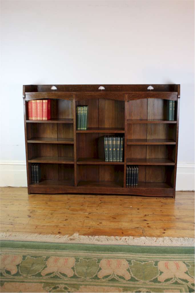 Liberty & Co Arts and Crafts oak open bookcase with pierced heart cut outs