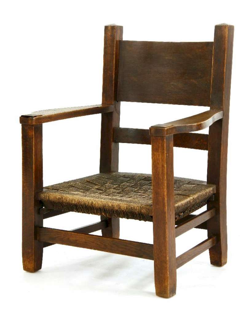 An Arts and Crafts oak 'mission' armchair,with a woven string seat