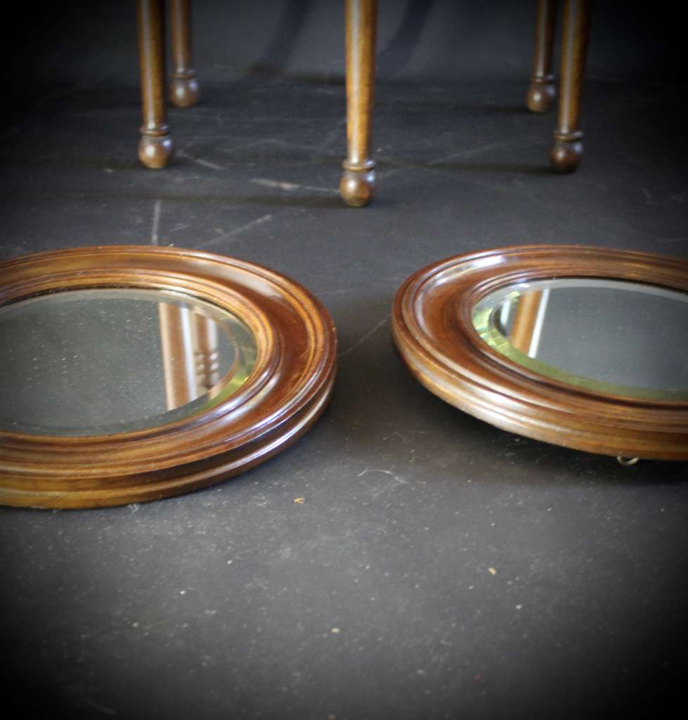 pair of oak framed circular mirrors
