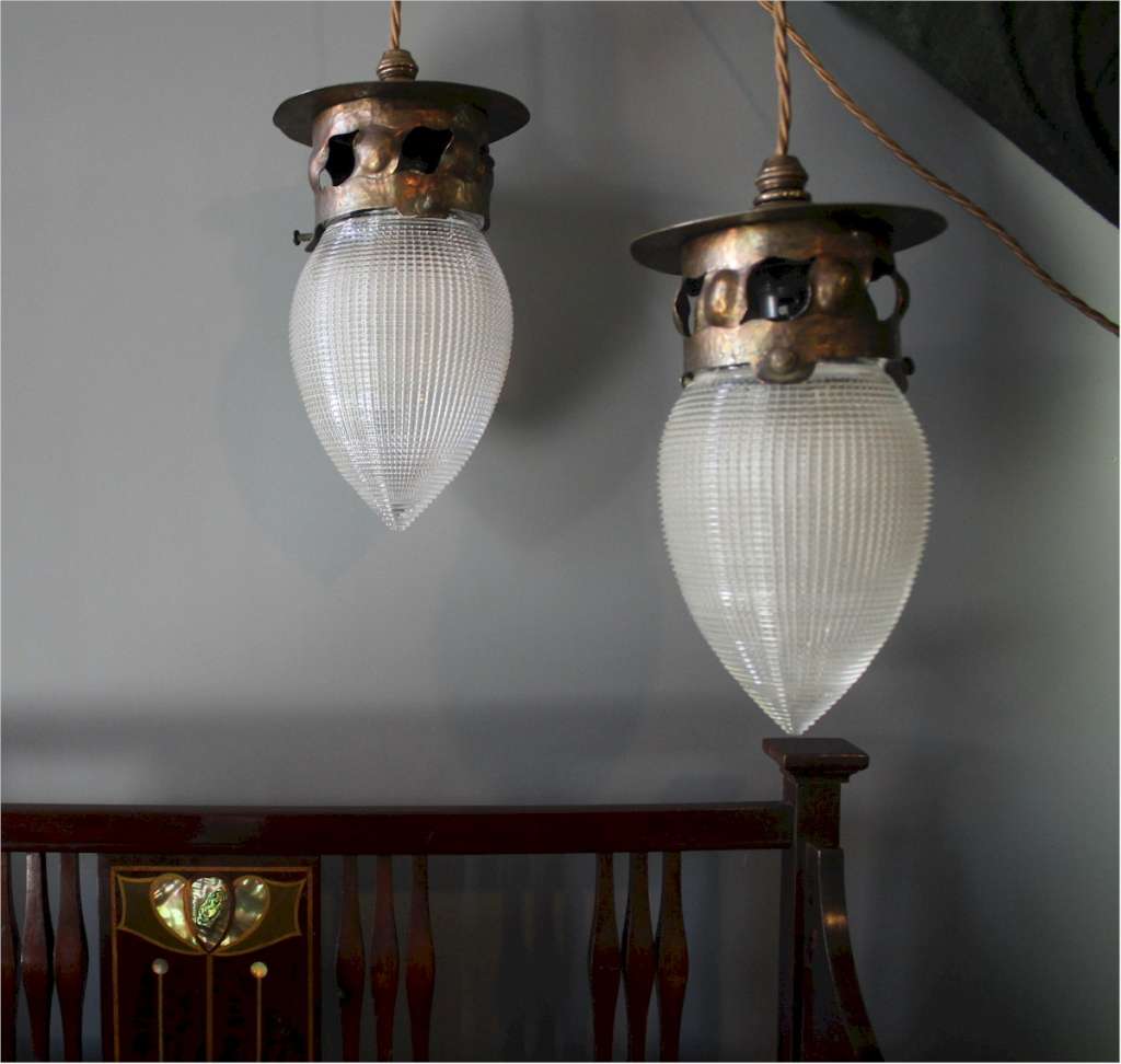 Pair of arts and crafts copper pendant lights with Holophane glass shades