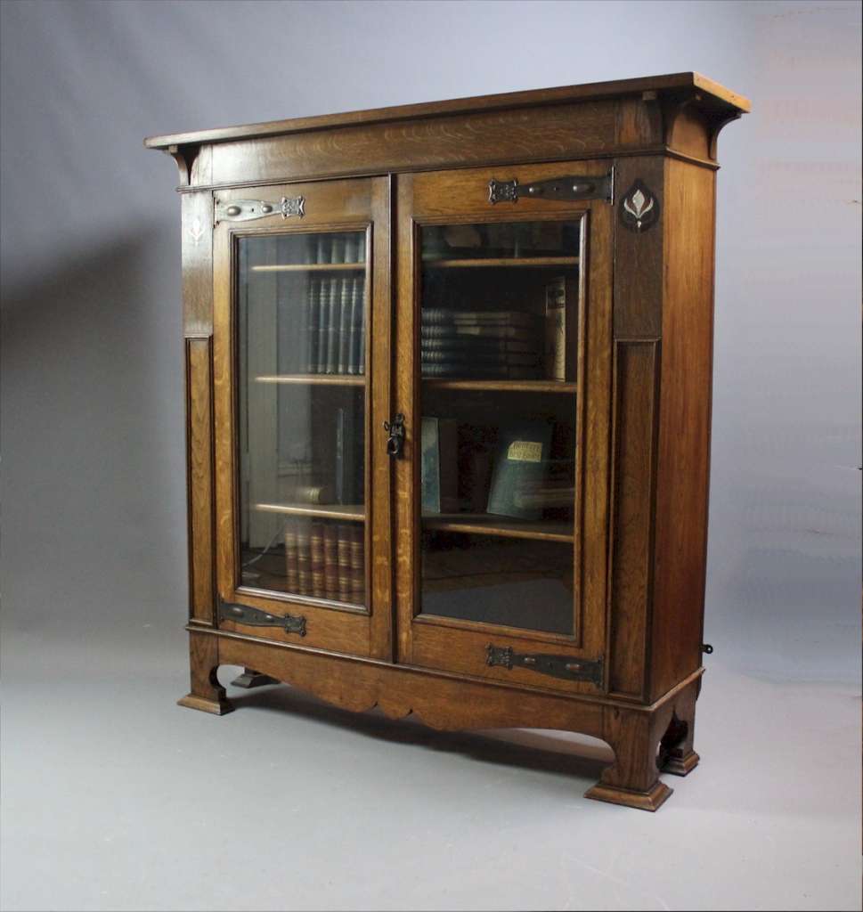 Pewter and ebony inlaid arts and crafts bookcase