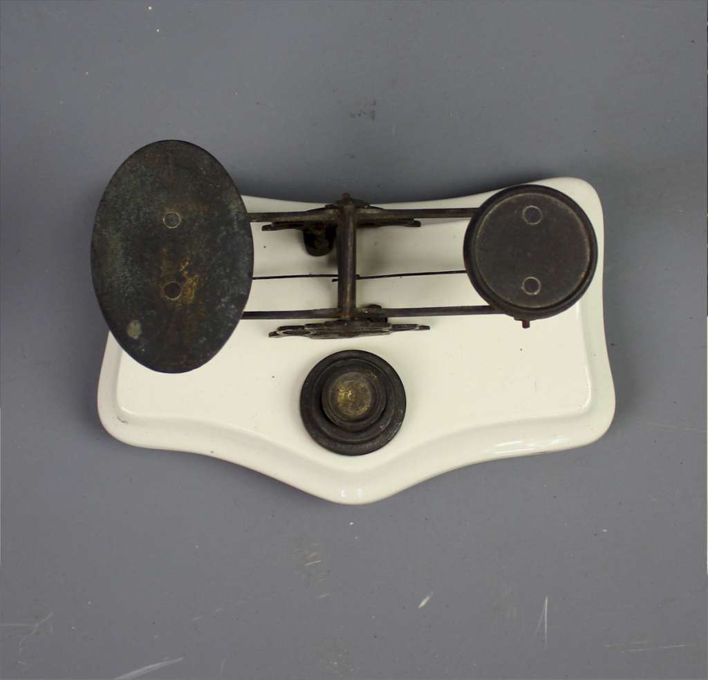 Ceramic and brass postal scales.