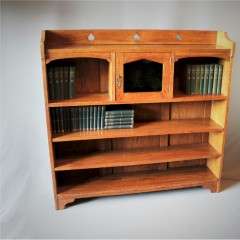 Arts and crafts oak bookcase with pierced spearhead cut-outs