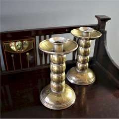 Pair of brass arts and crafts candlesticks