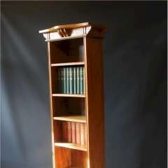 Tall Arts and Crafts oak open bookcase with shaped top