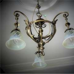 Arts and crafts brass hanging lamp with vaseline shades.