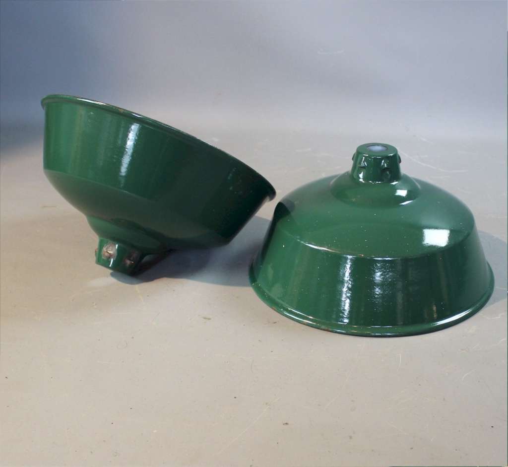 Two green enamelled industrial shades.