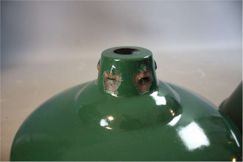 Two green enamelled industrial shades.