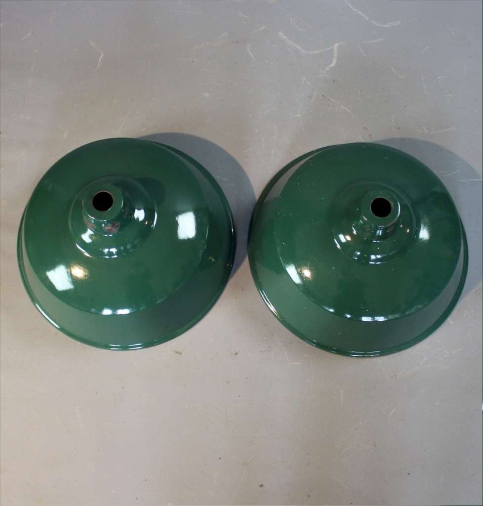 Two green enamelled industrial shades.